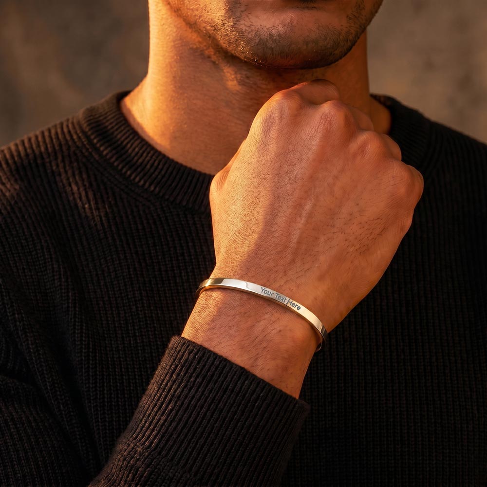 Man wearing a men's custom engraved cuff bracelet on his wrist