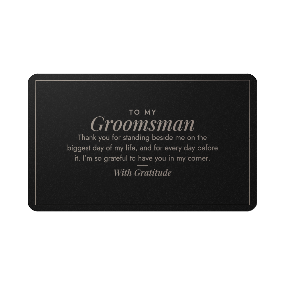 Engraved metal wallet card for groomsman held in hand