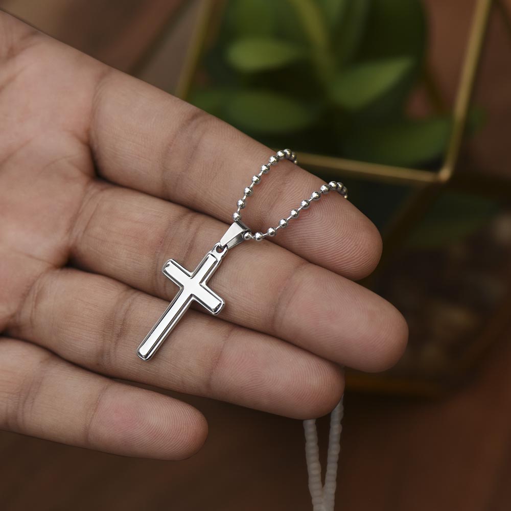 Cross necklace for daughter held in hand