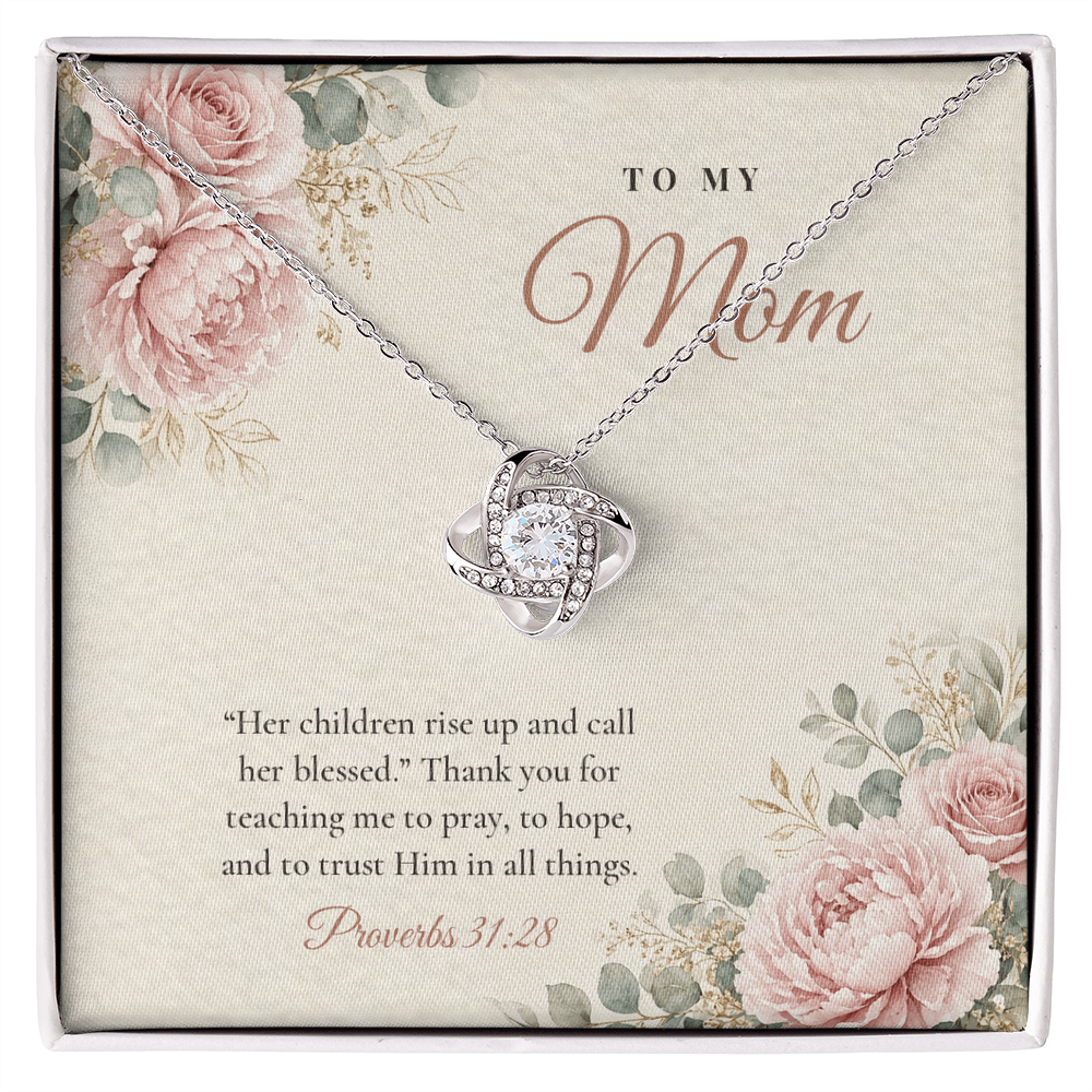 Christian Love Knot necklace for Mom laid on "To My Mom" Proverbs 31:28 message card