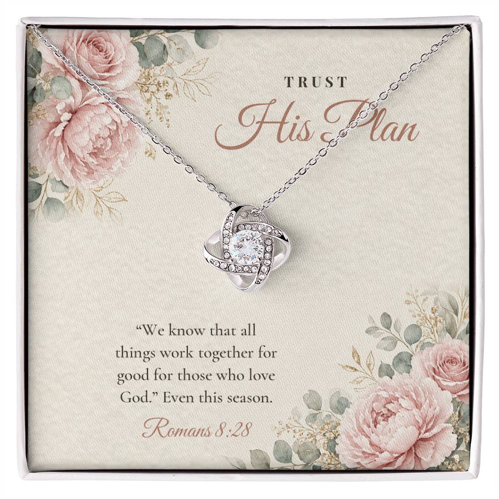 Christian Love Knot necklace laid on "Trust His Plan" Romans 8:28 message card