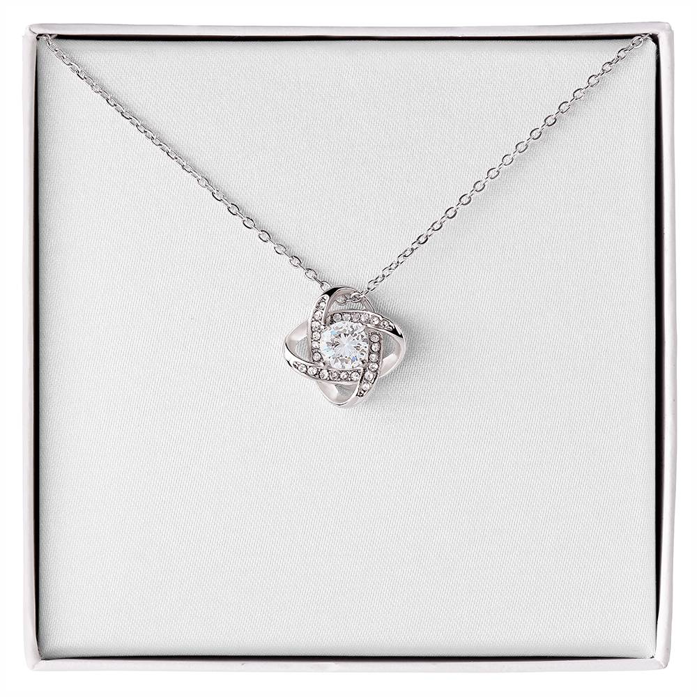 Christian Christmas Love Knot necklace laid on "O Holy Night" John 3:16 message card