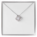 Christian Christmas Love Knot necklace laid on "O Holy Night" John 3:16 message card