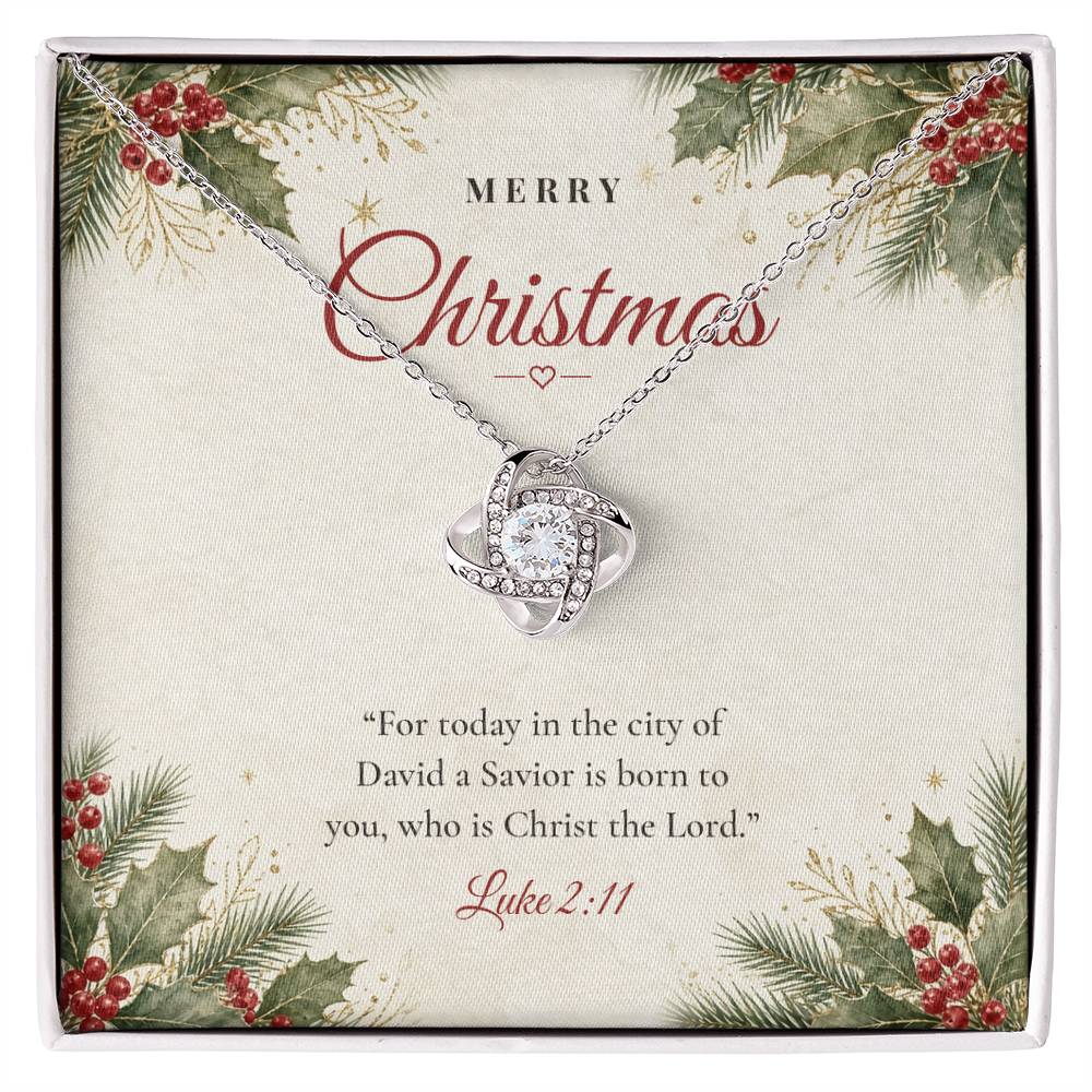 Christian Christmas Love Knot necklace laid on "Merry Christmas" Luke 2:11 message card