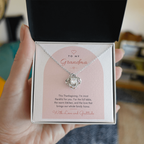 Hand holding open gift box with silver finish Love Knot necklace for Grandma and modern message card