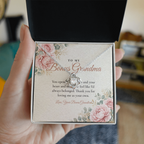 Hand holding gift box with silver Love Knot necklace for bonus grandma and To My Bonus Grandma message card