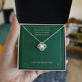 Hand holding gift box with white gold Love Knot necklace for daughter from Dad and You Always Have a Home With Me message card