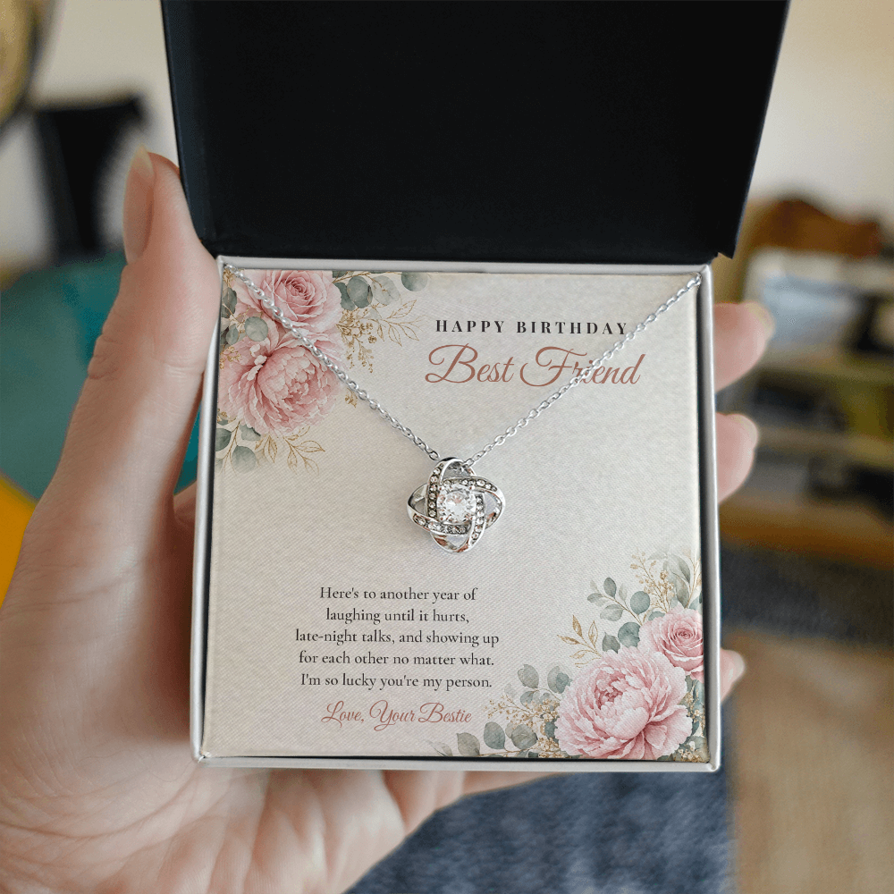 Hand holding open gift box with 14K white gold finish Birthday Love Knot necklace for Best Friend and "Happy Birthday Best Friend" message card