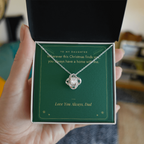 Hand holding gift box with white gold Love Knot necklace for daughter from Dad and You Always Have a Home With Me message card