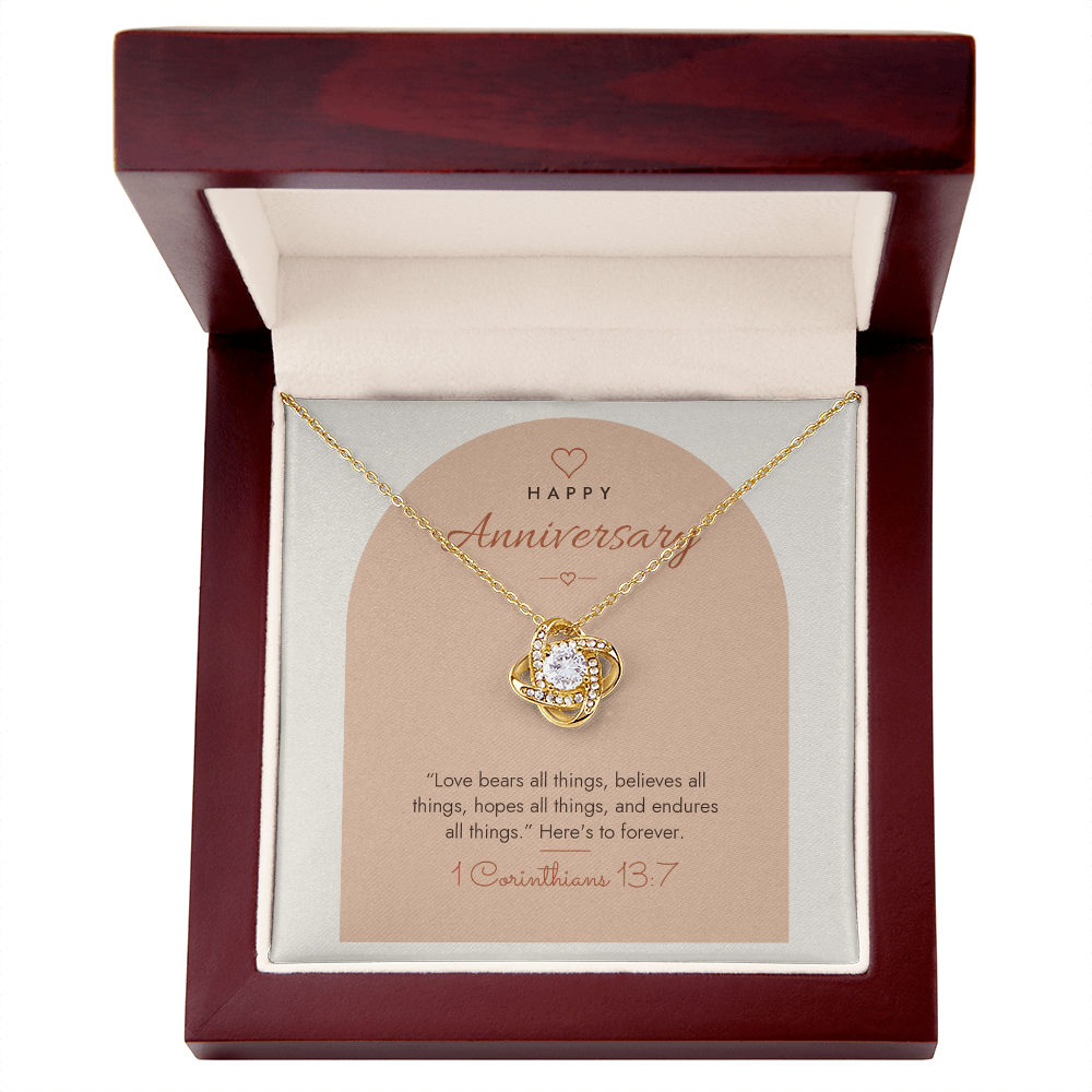 18K yellow gold finish Christian Love Knot necklace for Anniversary in mahogany luxury gift box with lid open, "Happy Anniversary" 1 Corinthians 13:7 modern message card