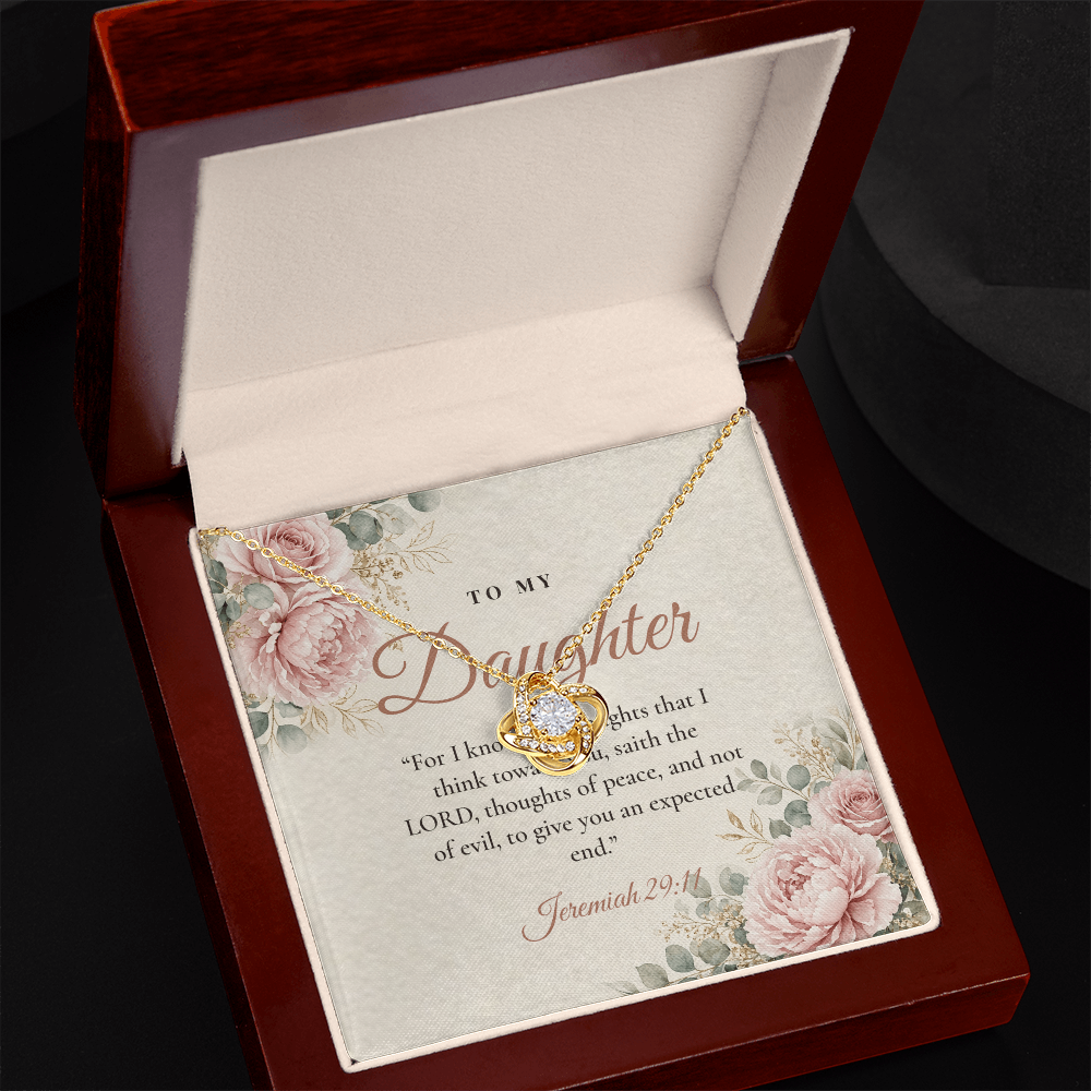 Yellow gold Love Knot necklace for daughter and To My Daughter Jeremiah 29:11 message card in open mahogany luxury box on dark background
