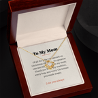 Yellow gold Love Knot necklace and To My Mom message card in open mahogany luxury box on dark background