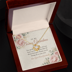 Yellow gold Love Knot necklace for bonus grandma and To My Bonus Grandma message card in open mahogany luxury box on dark background