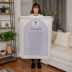 Woman holding a lavender strength prayer blanket with printed prayer in a living room