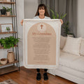 Woman holding a peach prayer blanket for grandma with printed prayer in a living room