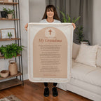 Woman holding a peach prayer blanket for grandma with printed prayer in a living room