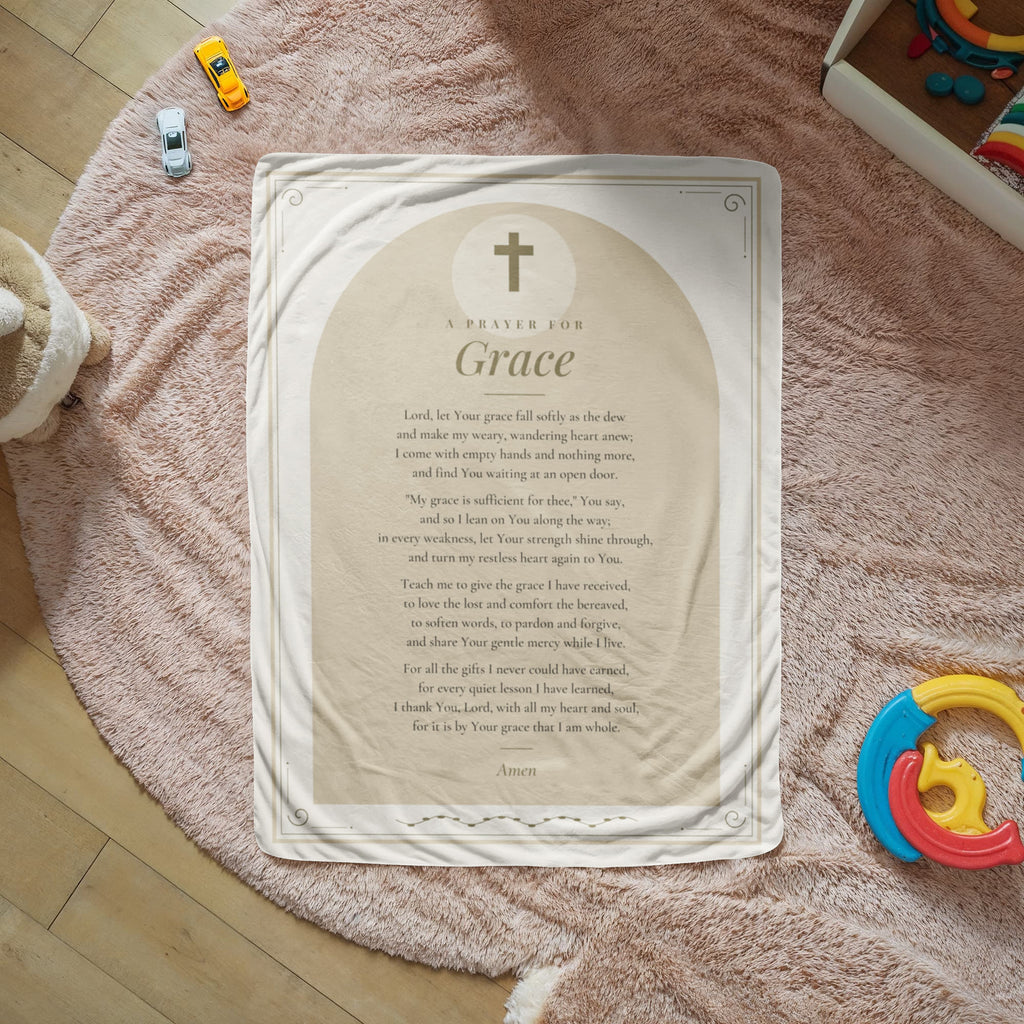 Tan grace prayer blanket with printed prayer spread on a cozy rug