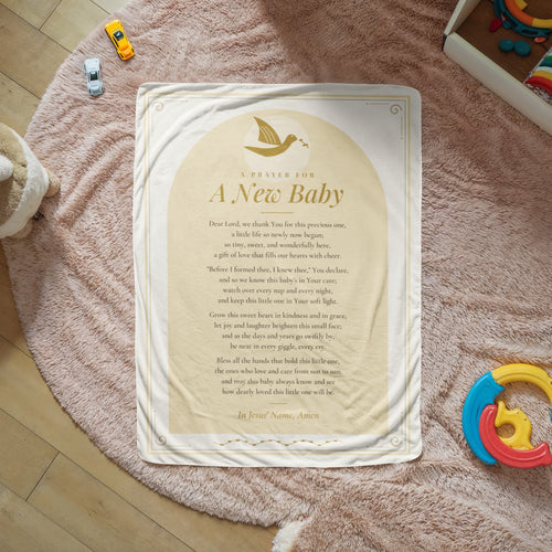 Cream baby prayer blanket with printed prayer spread on a cozy rug
