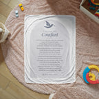 Gray comfort prayer blanket with printed prayer spread on a cozy rug