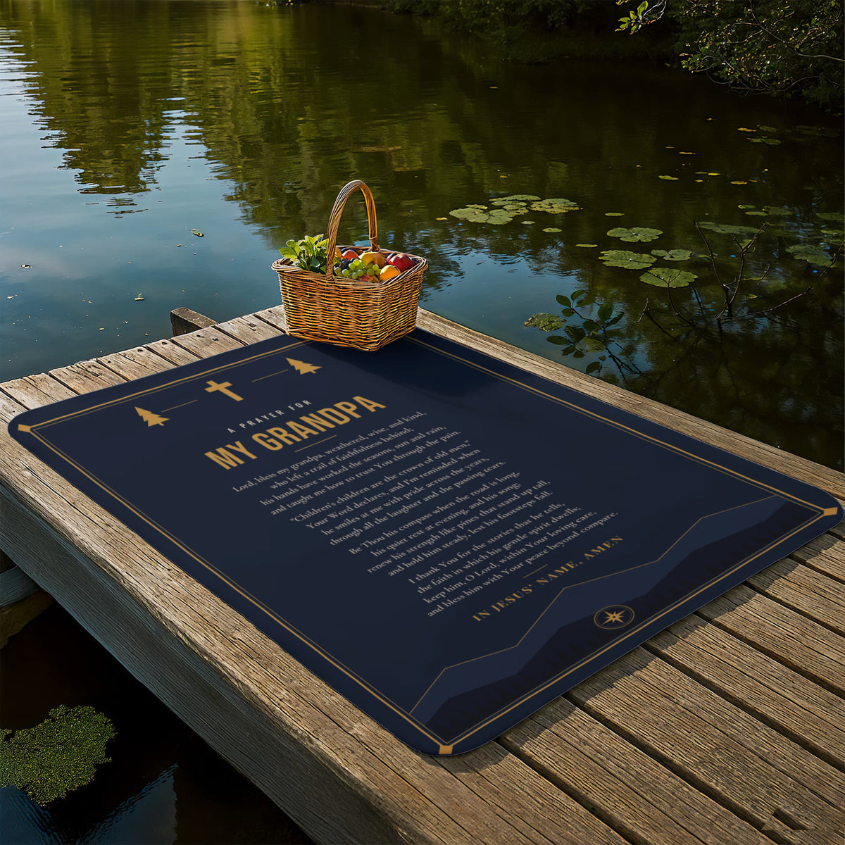 Navy blue prayer blanket for grandpa laid out on a lakeside dock with picnic basket